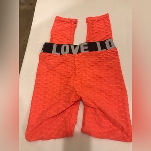 C)  Ladies Orange Scrunch Butt Leggings L/XL.  NWOT